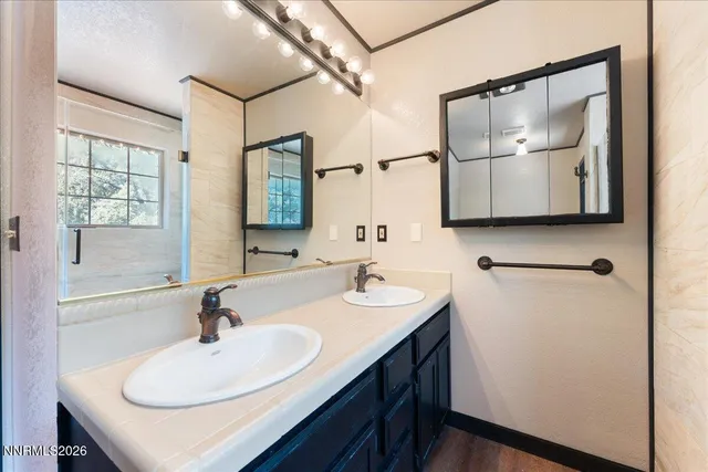a bathroom with 2 sink and a mirror