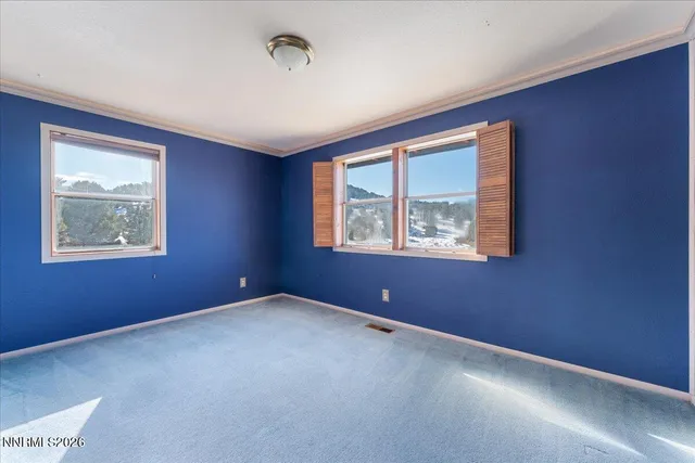 an empty room with windows and closet