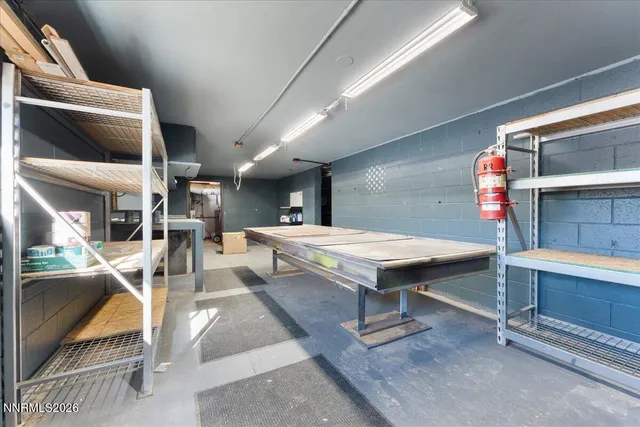 a living room with table chairs and a table