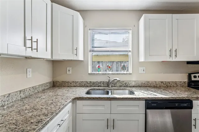 a view of a refrigerator in kitchen and a glass window