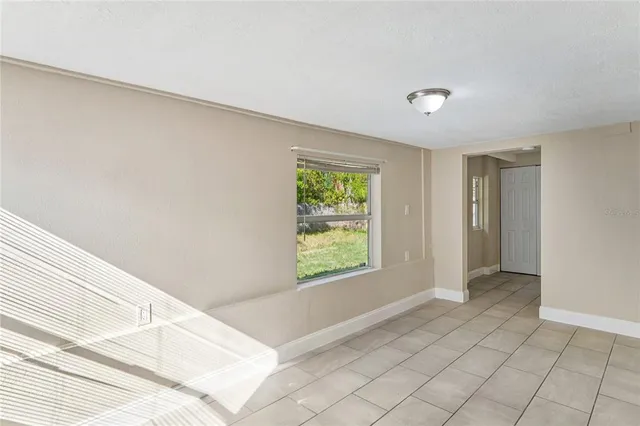 a view of an empty room with a closet