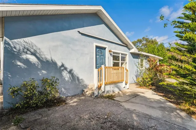 an empty room with closet and a chandelier fan