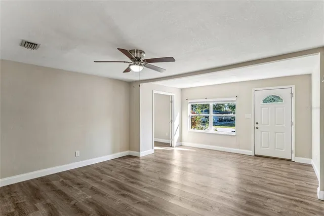 a kitchen with stainless steel appliances granite countertop a stove top oven a sink and dishwasher a refrigerator with wooden floor