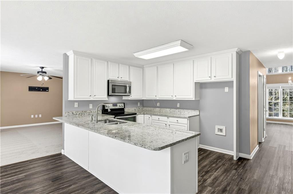 5976 Bowers Road Stone Mountain, GA 30087 - Photo 7 of 31 a kitchen with stainless steel appliances granite countertop a sink stove and refrigerator