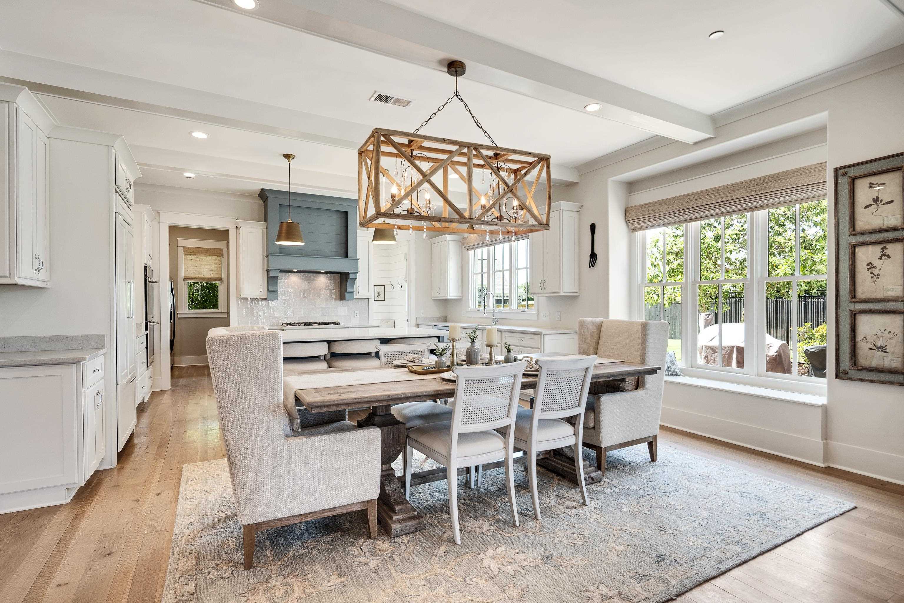 100 Sunflower View Road Piperton, TN 38017 - Photo 9 of 29 Kitchen and dining area featuring light wood-finish flooring and white cabinetry