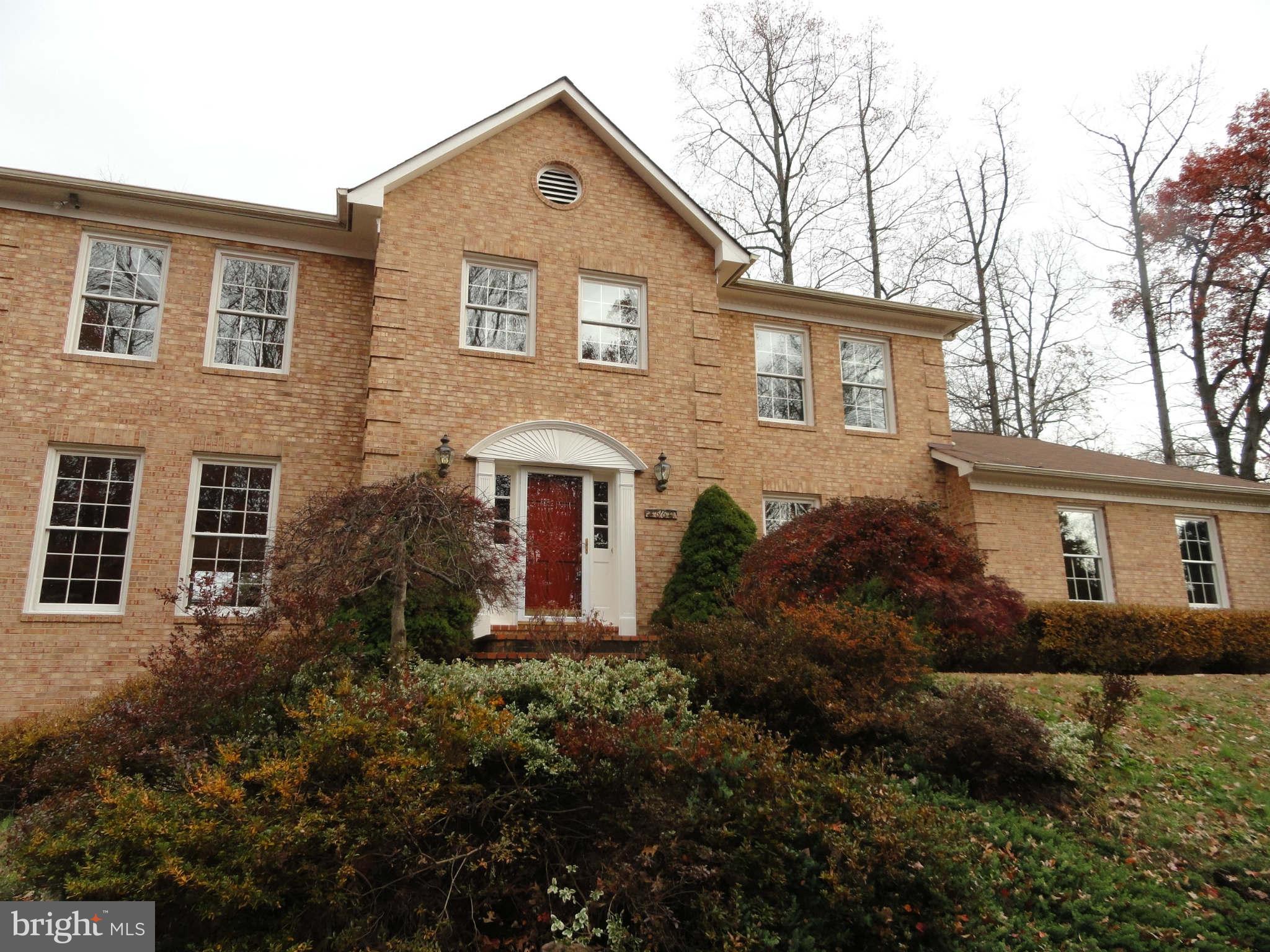 8660 Center Road, Unit 1 Springfield, VA 22152 - Photo 1 of 25 a front view of a house with a yard