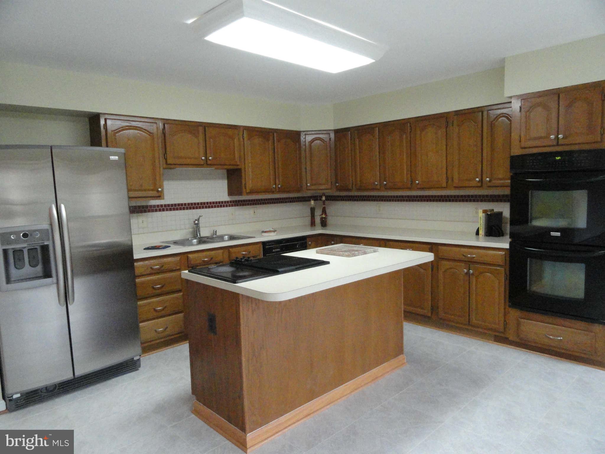 8660 Center Road, Unit 1 Springfield, VA 22152 - Photo 5 of 25 a kitchen with a stove sink and refrigerator