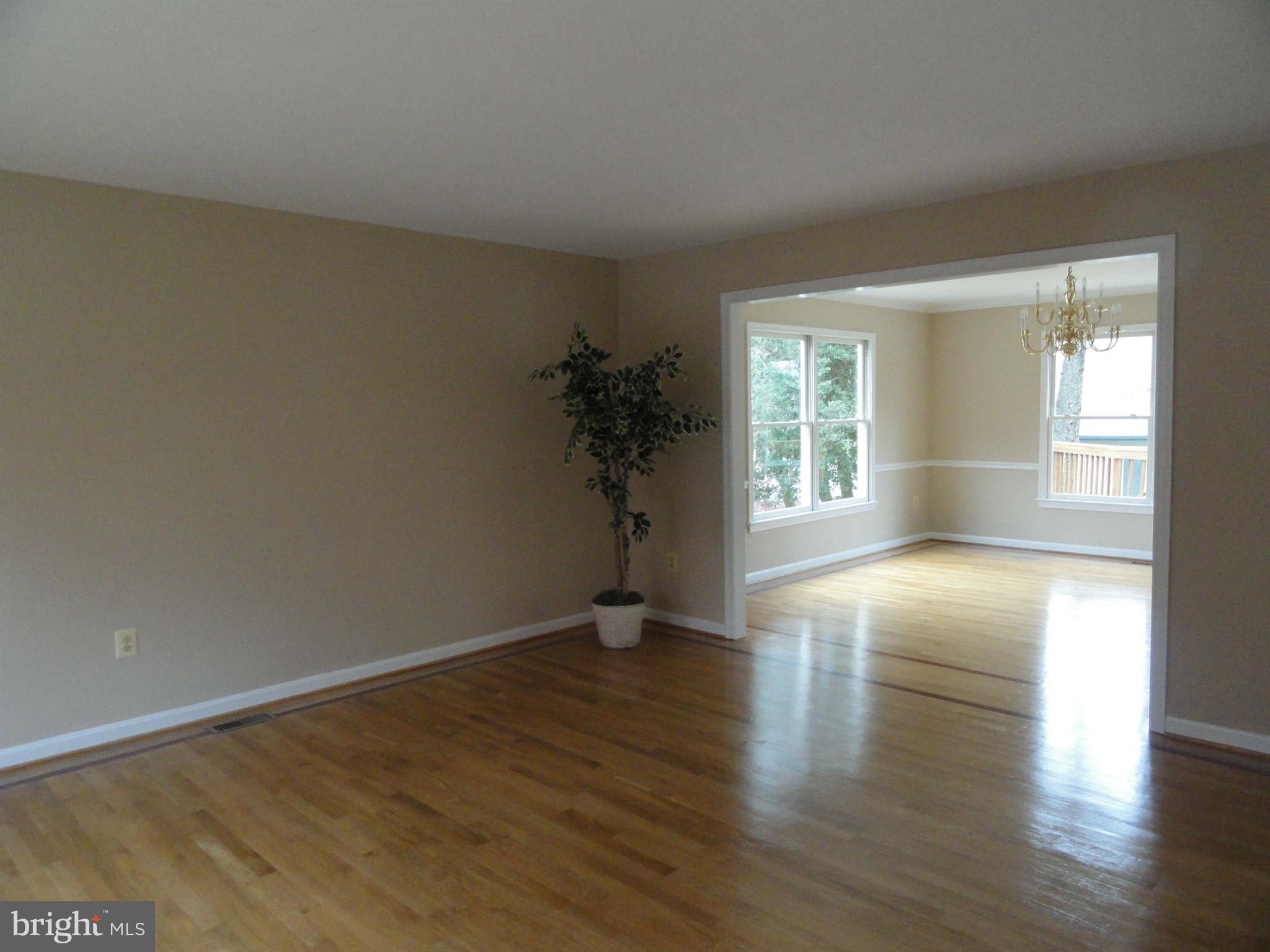 8660 Center Road, Unit 1 Springfield, VA 22152 - Photo 9 of 25 an empty room with wooden floor and windows