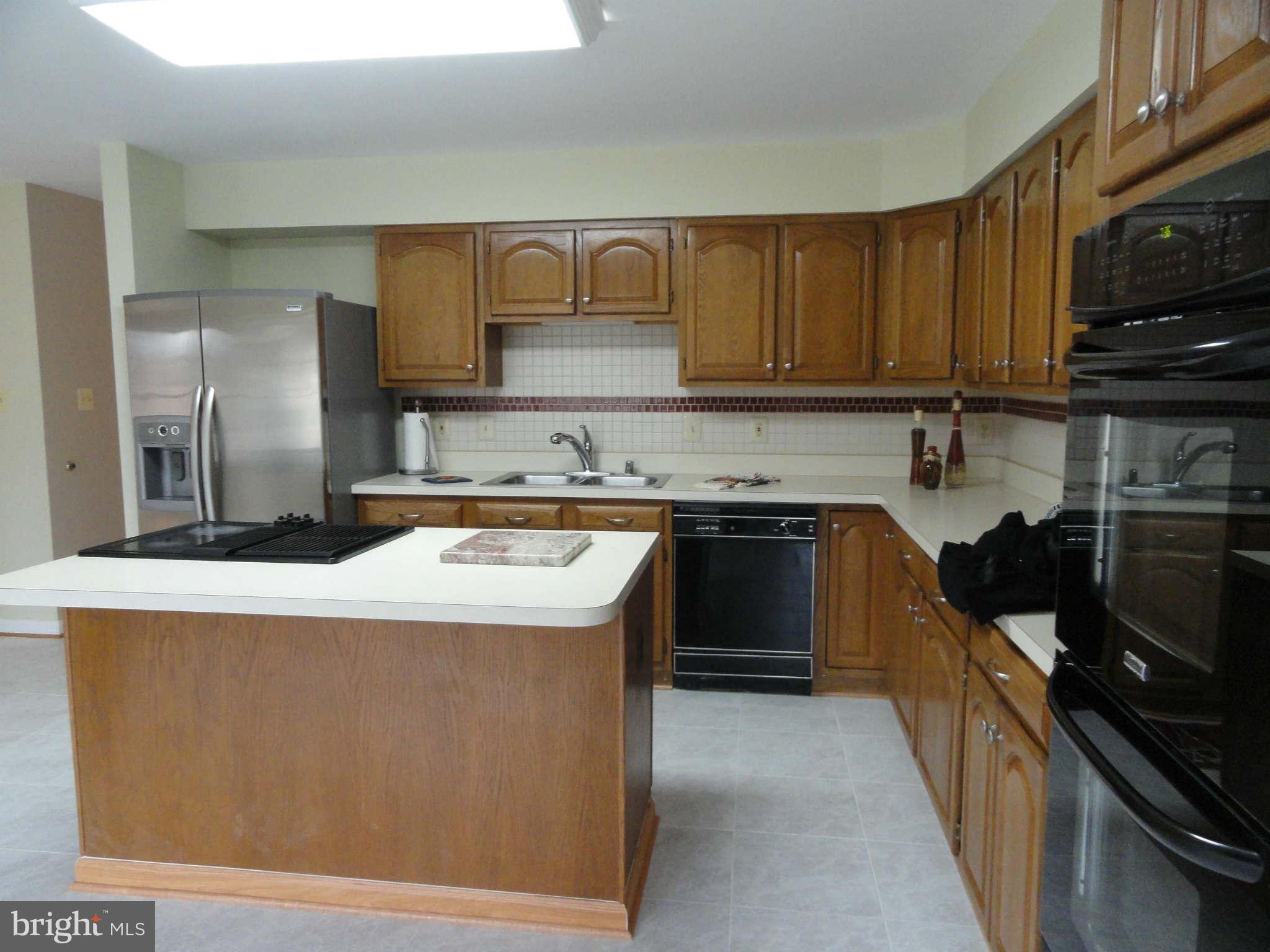 8660 Center Road, Unit 1 Springfield, VA 22152 - Photo 10 of 25 a kitchen with stainless steel appliances granite countertop a stove a sink and a refrigerator