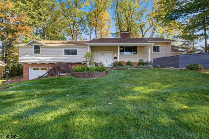 113 Barchester Way Westfield, NJ 07090 - Photo 1 of 40 a front view of a house with a garden and yard