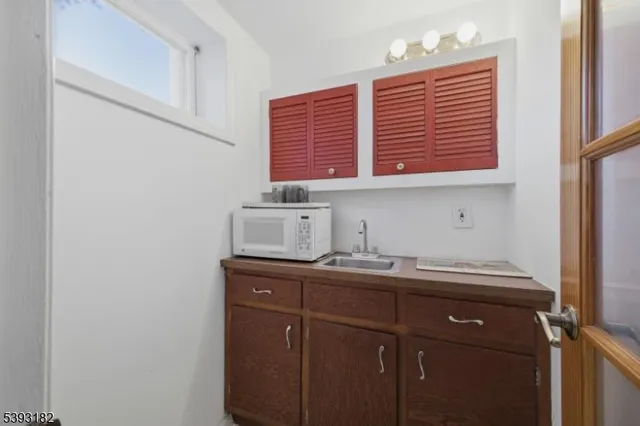 a kitchen with a sink cabinets and a window