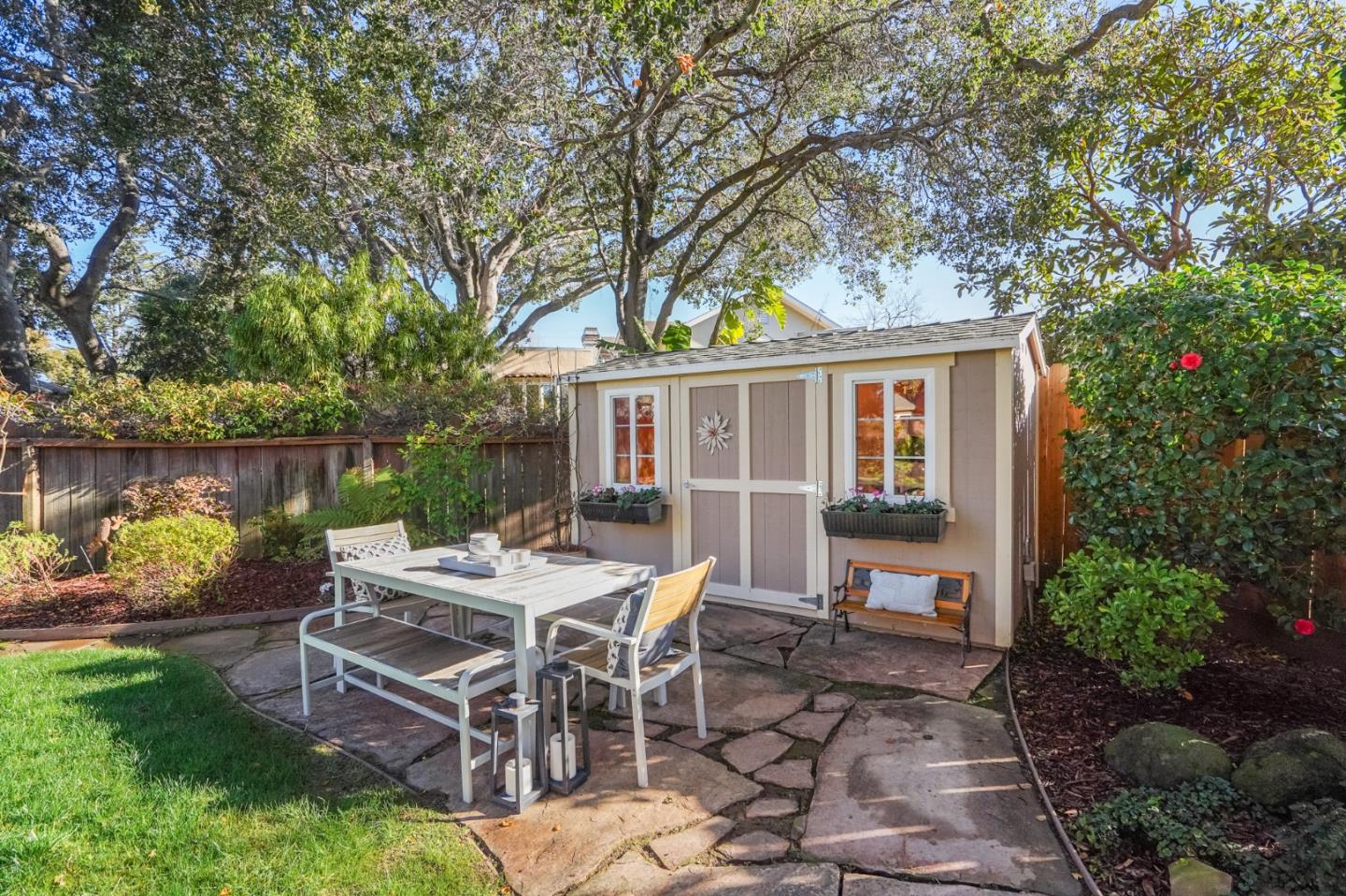 30 Bancroft Road Burlingame, CA 94010 - Photo 36 of 42 a view of a patio with table and chairs potted plants and large tree
