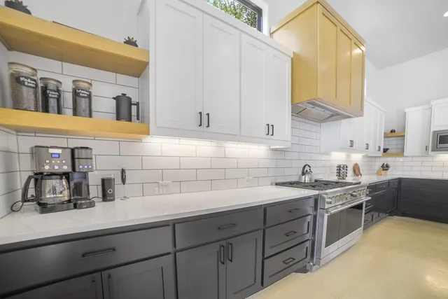 a kitchen with a sink dishwasher and cabinets