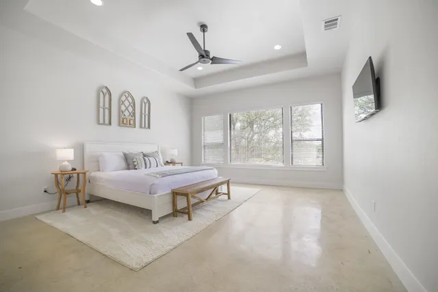 a spacious bedroom with a bed and a window