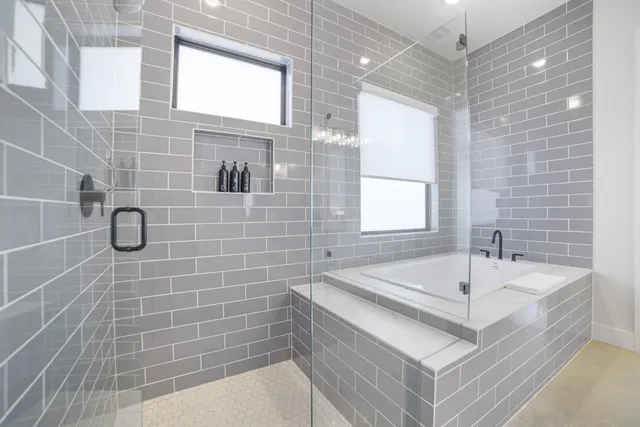 a bathroom with a bathtub and shower