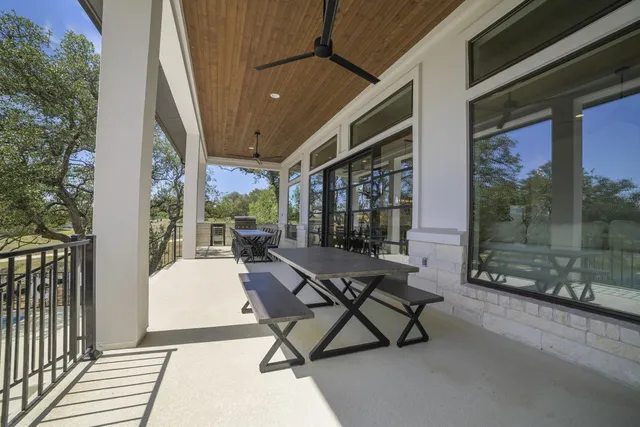 a building outdoor space with patio furniture and potted plants