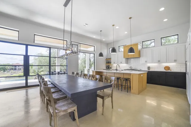 a kitchen with a table chairs sink and cabinets