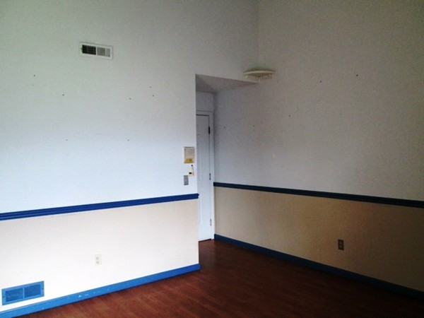 64 Tennis Plaza Road, Unit 2 Dracut, MA 01826 - Photo 11 of 20 an empty room with wooden floor