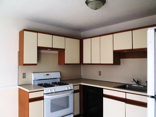 64 Tennis Plaza Road, Unit 2 Dracut, MA 01826 - Photo 3 of 20 a kitchen with appliances cabinets and a sink