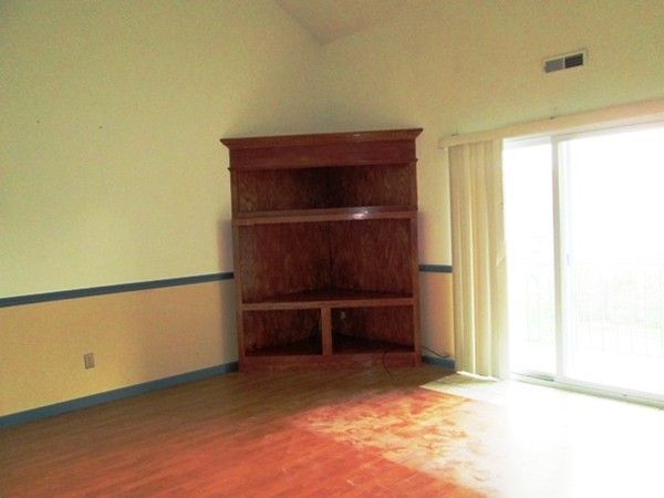 64 Tennis Plaza Road, Unit 2 Dracut, MA 01826 - Photo 7 of 20 a room with a wooden bench and a window