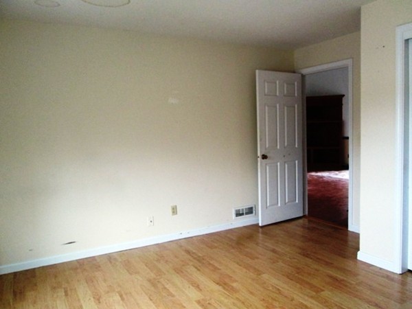 64 Tennis Plaza Road, Unit 2 Dracut, MA 01826 - Photo 9 of 20 an empty room with wooden floor