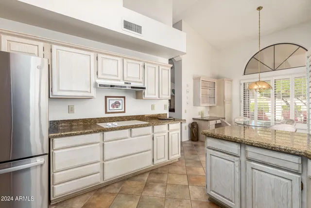 a kitchen with stainless steel appliances granite countertop a sink a stove and cabinets