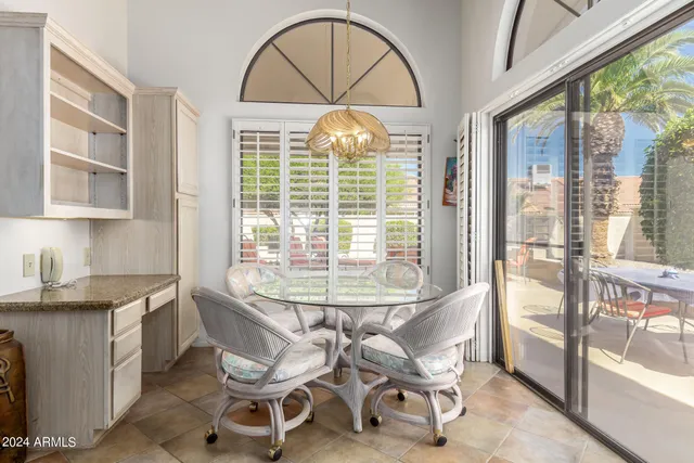 a dining room with furniture a chandelier and wooden floor