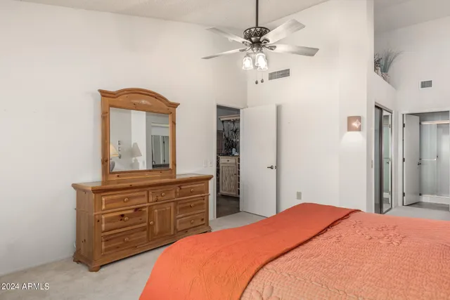 a bedroom with a bed and a dresser