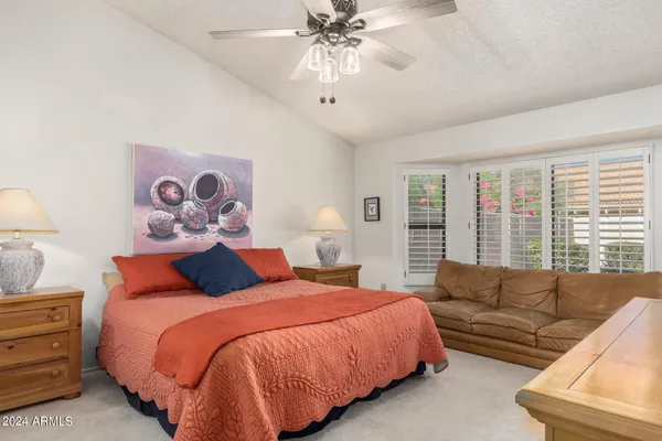 a bedroom with a bed and a couch