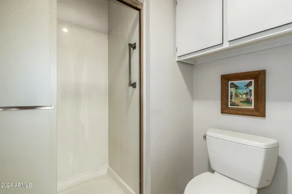 a white toilet sitting next to a bathroom sink