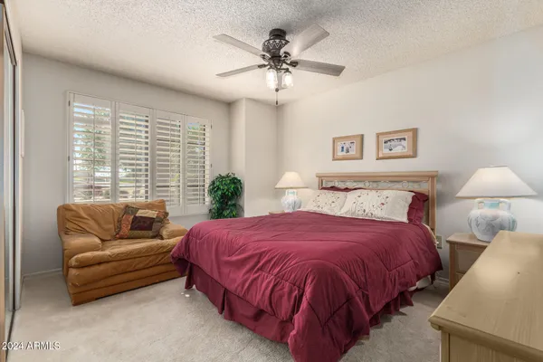 a bedroom with bed and a couch