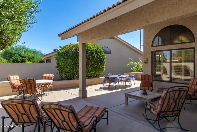 a view of a patio with table and chairs and potted plants