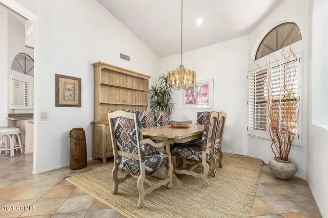 a dining room with furniture and window