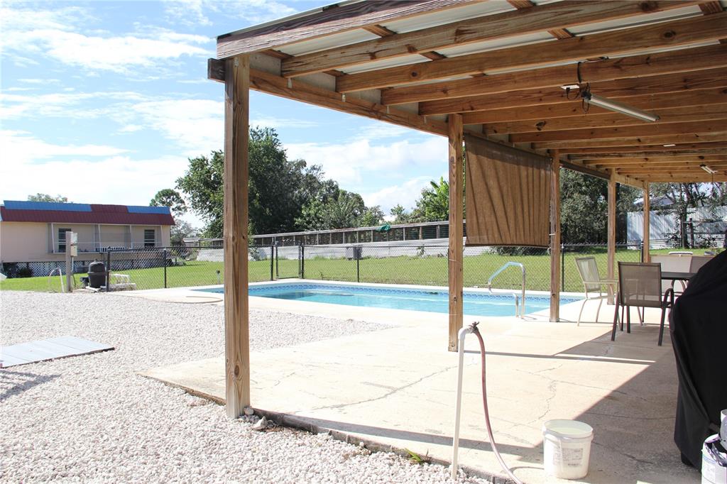 13127 Star Road Brooksville, FL 34613 - Photo 14 of 54 a view of a backyard with a swimming pool