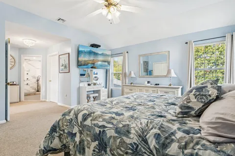 a bedroom with a large bed and a chandelier