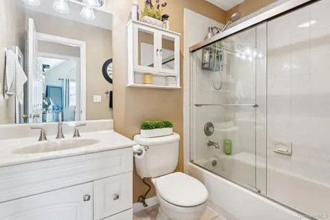 a bathroom with a toilet a sink and a mirror