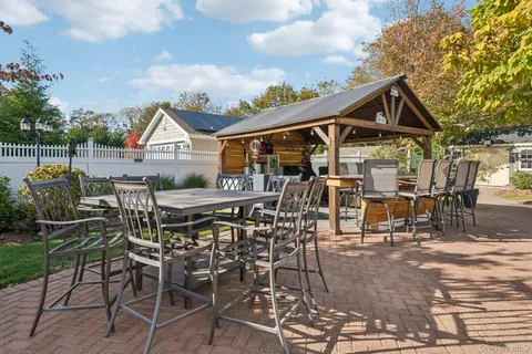 a view of a patio with table and chairs and potted plants