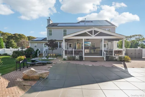 a view of a house with backyard porch and sitting area
