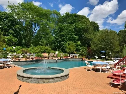 a backyard of a house with fire pit and outdoor seating
