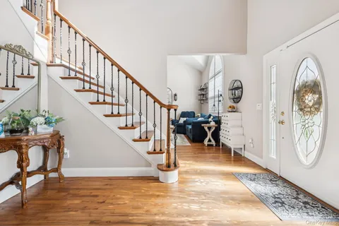 a view of an entryway with wooden floor