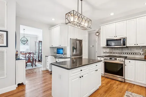 a kitchen with stainless steel appliances a stove sink microwave and cabinets
