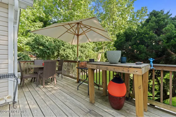 a view of deck with furniture and umbrella