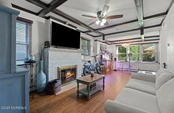 a living room with furniture fireplace and a flat screen tv
