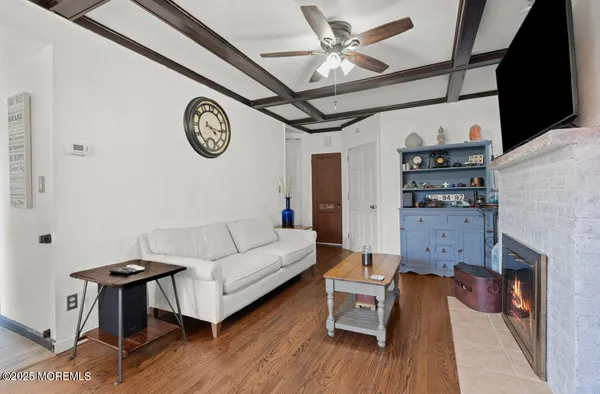 a living room with furniture a clock and a fireplace