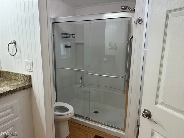 a bathroom with a shower and a sink