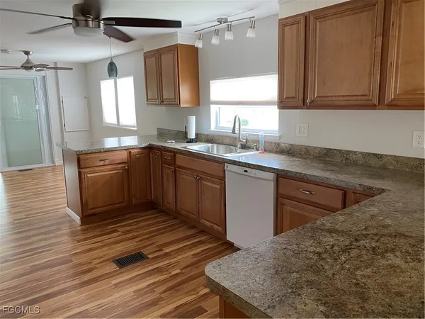 a kitchen with stainless steel appliances granite countertop a sink stove and cabinets