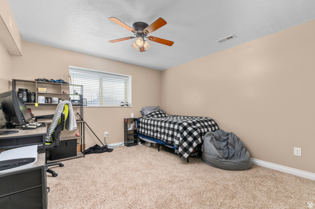 5702 950 North Ogden, UT 84404 - Photo 35 of 36 Carpeted room featuring a single window with blinds, a ceiling fan with light fixture, neutral wall paint, and white trim
