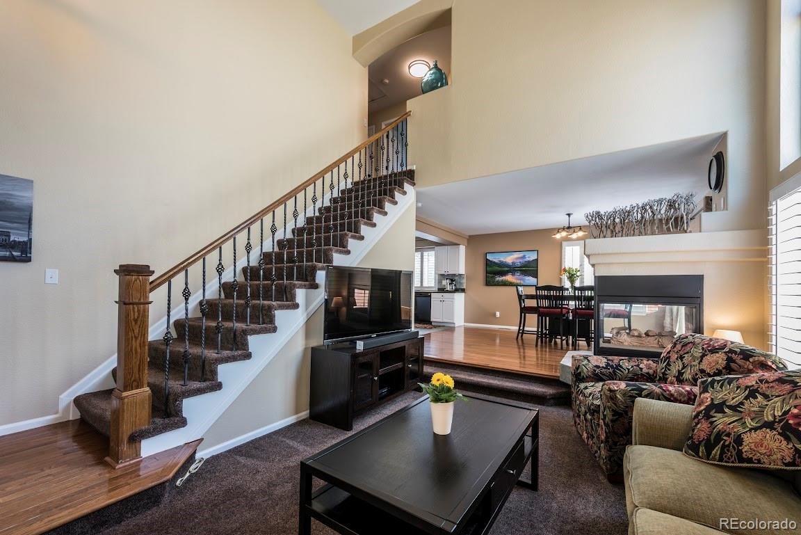 1279 Braewood Avenue Highlands Ranch, CO 80129 - Photo 14 of 20 a view of a livingroom with furniture and a ceiling fan