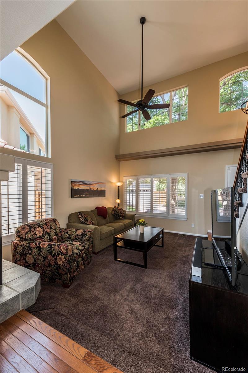 1279 Braewood Avenue Highlands Ranch, CO 80129 - Photo 15 of 20 a living room with furniture window and wooden floor