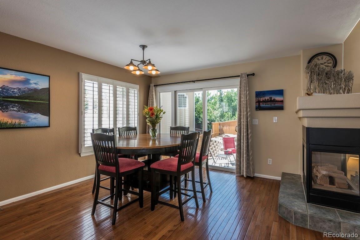 1279 Braewood Avenue Highlands Ranch, CO 80129 - Photo 16 of 20 a view of a dining room with furniture window and wooden floor